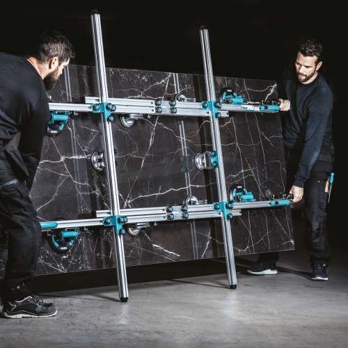 BIHUI large format lifting system supporting a large porcelain tile during installation on a construction site. 2