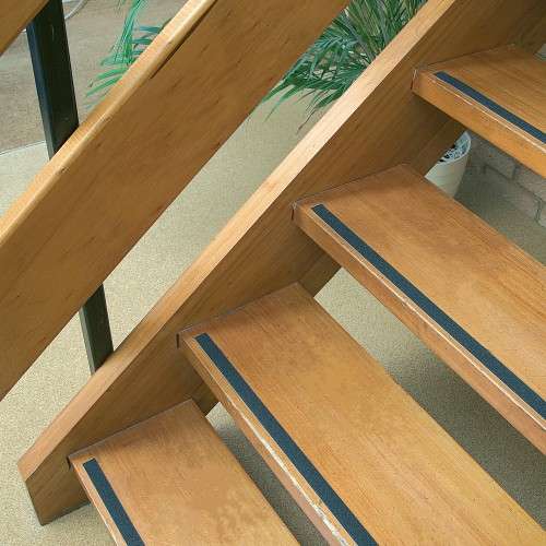 Silicone carbide safety tape applied to stair edge for slip resistance and improved safety on indoor and outdoor surfaces.