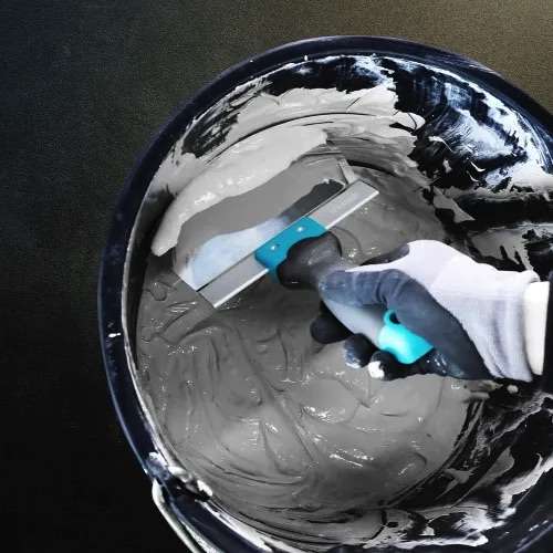 Stainless steel curved bucket scoop scraper 6.5 inch used for scooping and cleaning materials from a mixing bucket. 1